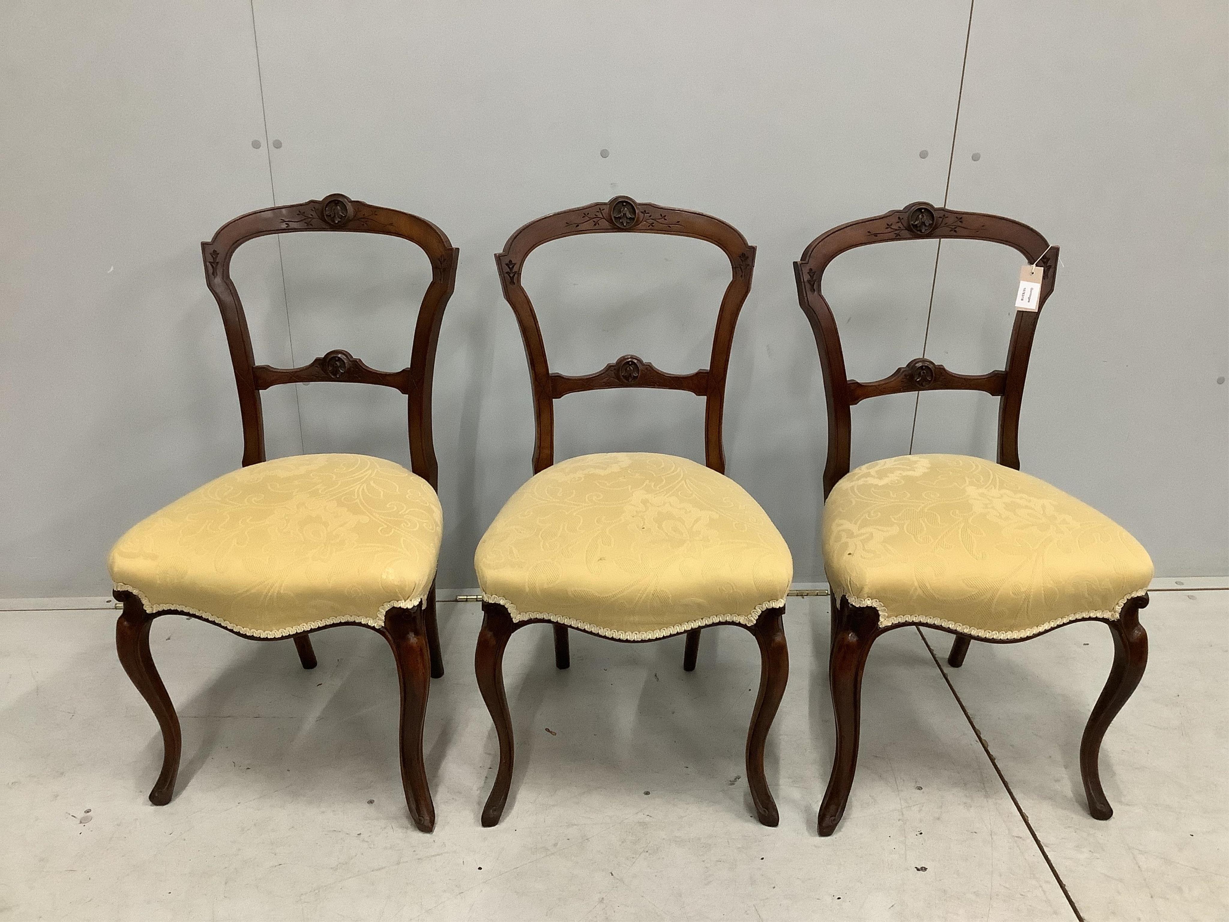 Three Victorian walnut dining chairs, on cabriole legs. Condition - fair